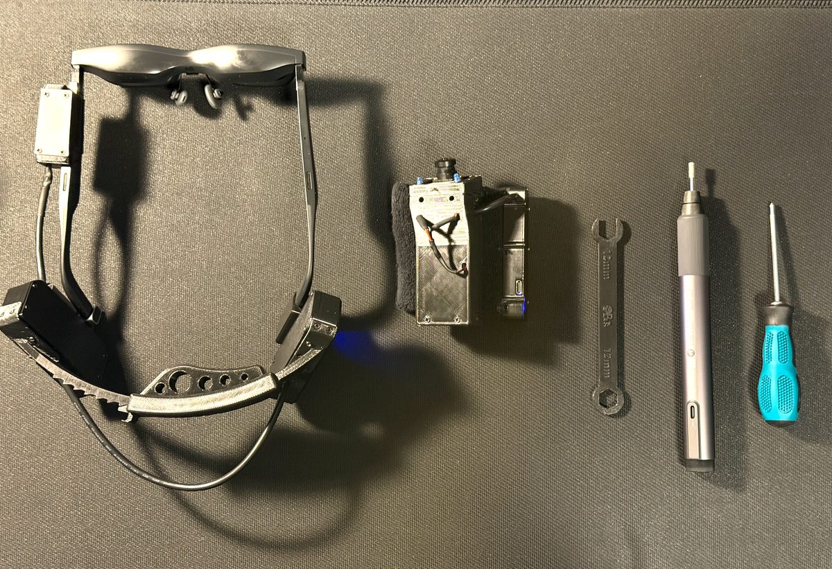 The full SULTEK OPTICALS prototype kit: MIRAGE glasses and wrist camera unit beside assembly tools
